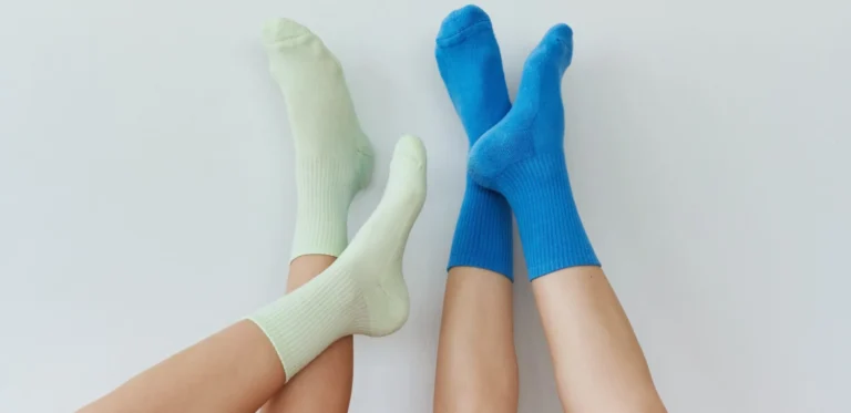 Legs wearing light green and blue compression socks.